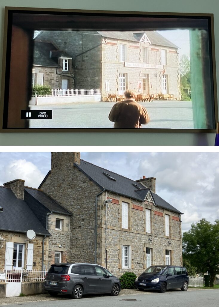 A side-by-side comparison of a scene from the show 'The Darling Buds of May' displayed on a TV, alongside a current photograph of the filming location, showcasing the rustic architecture and outdoor seating area.